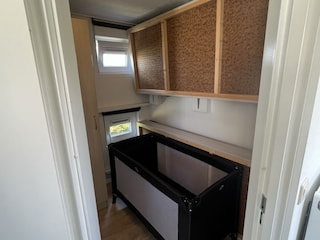 Beds folded up in the small bedroom