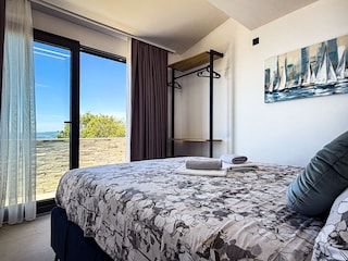 Das Schlafzimmer mit Balkon und Meerblick