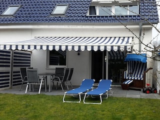 Terrasse mit Strandkorb, Tisch und Liegen