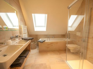 Badezimmer mit Badewanne und Dusche