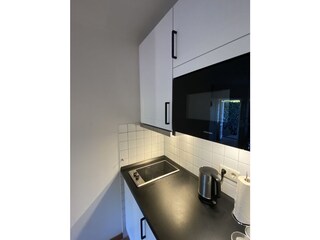 Küchenzeile mit Ceranplatte und Mikrowelle
