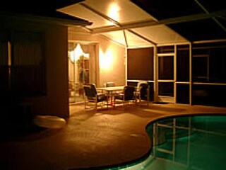 at night with lighted pool and romatic atmosphere