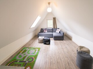 A cozy playroom with toys for children.