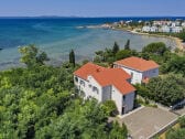 House and sandy beach behind