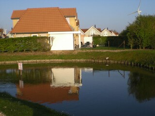 View from the house over the picturesque lake towards the house