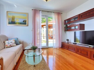 Spacious living area on the ground floor with TV, AC