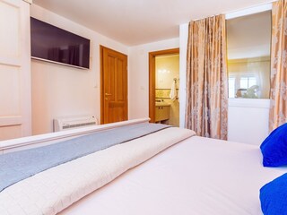 Bedroom No1. with double bed, TV, and en-suite bathroom