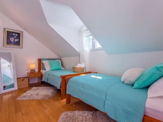 Bedroom No.4. two single beds, TV, and  bathroom