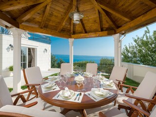 outdoor dining area with barbecue next to living room