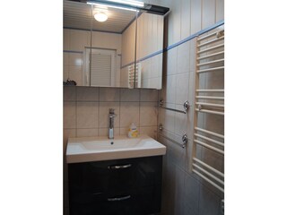 Badezimmer mit Waschplatz und Handtuchwärmer