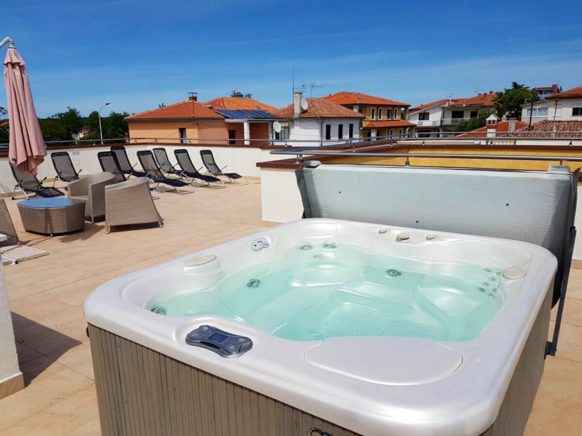 Roof terrace with deck chairs and jacuzzi