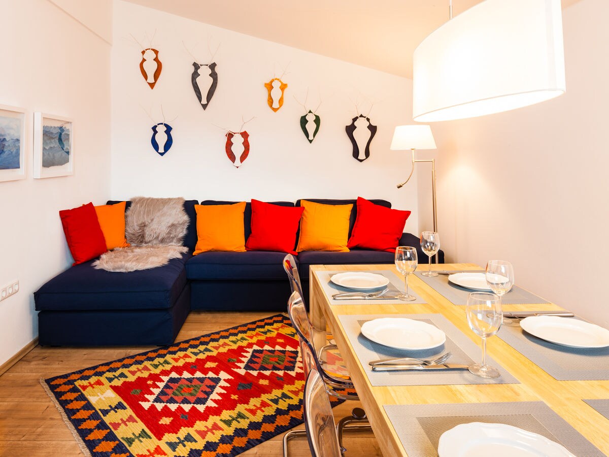 The living room with large dining table has a balcony.