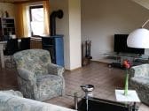 Living room with fireplace and TV