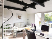 light-flooded living room with balcony with sea view