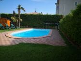 Swimming pool with sun chairs