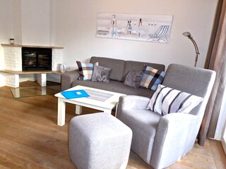 fireplace with sofa and rocking armchair
