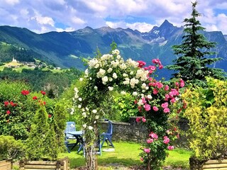 Garten mit Rosenbogen und herrlichem Bergblick