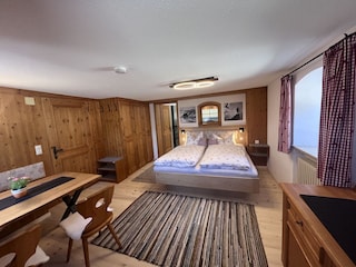 Schlaf und Wohnzimmer mit gemütlichen Tannenholz