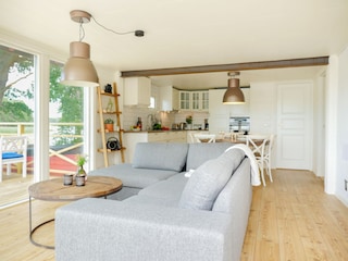 Vorne Wohnzimmer mit Glasfassade & hinten moderne Küche