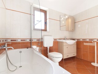 Bathromm with shower and bathub