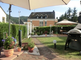 Garden with sunbathing lawn and pond.