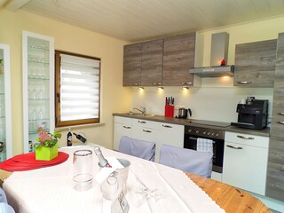 Kitchen with dishwasher and automatic coffee machine.