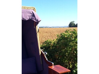 In a beach chair with a view over the fields to the sea