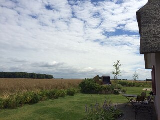 Seating area behind the villa with a view over the fields