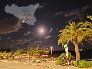 Bungalow Park in Sicily at the sandy beach at night