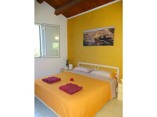 Double bed in the  bungalow La Perla di Sicilia