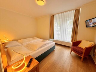 1. Schlafzimmer mit Doppelbett und zusätzlichem TV