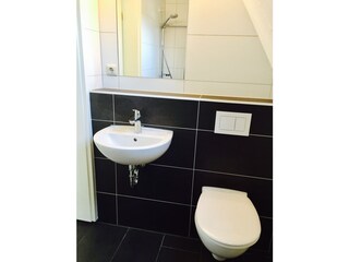 Bathroom with ground-level shower and plenty of daylight