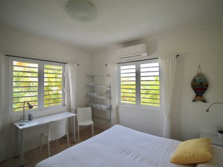 Bedroom 1 with desk and shutter windows