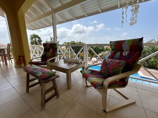 Comfortable lounge chairs on the roofed terrace