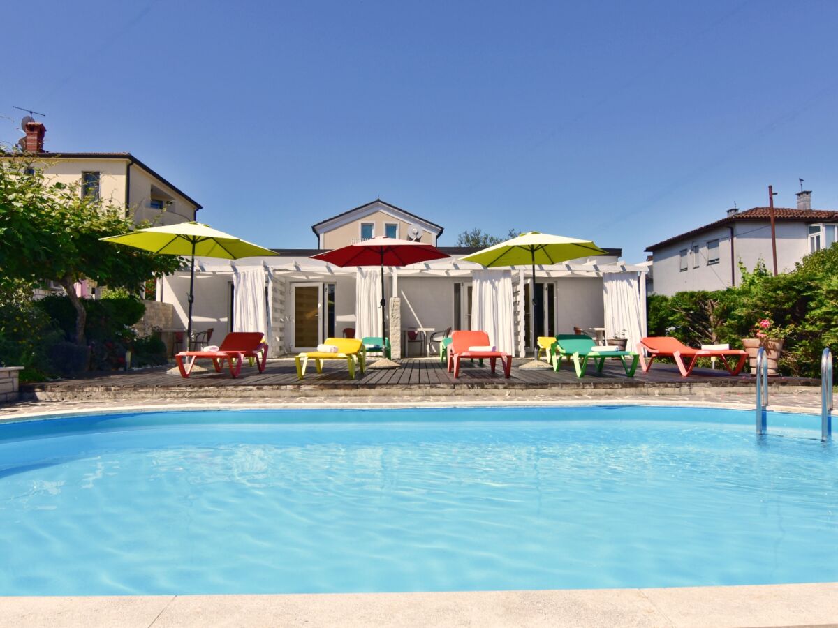 Swimming pool with sun loungers and parasols