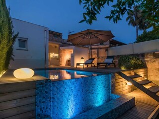 View from the garden onto pool, terrace and house
