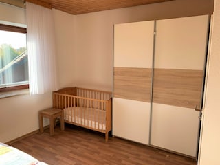Babybett im Schlafzimmer in der Wohnung Meeresbrise