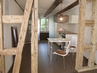 Modern kitchen and bathroom in the background.