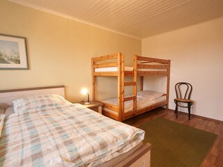 Schlafzimmer mit Doppelbett und Etagenbett