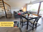 Living room with dining space and view of the balcony