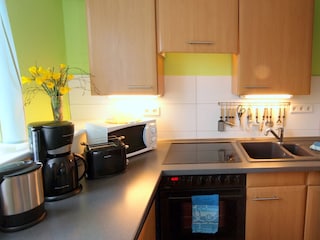 Küche mit Spülmaschine und Backofen