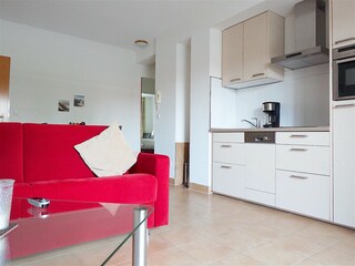 Strandpalais Ferienwohnung 21 -  Wohnzimmer mit Küche