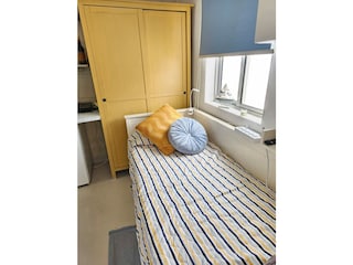 Single bed by the window
