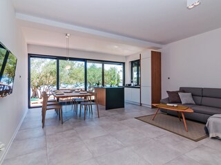 living room with kitchen and exit to terrace