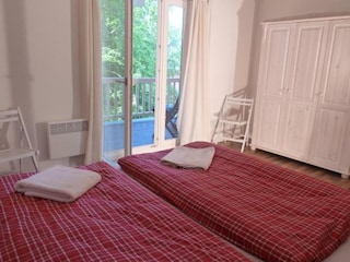 Schlafzimmer mit Doppelbett und privatem Balkon