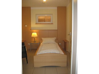 Schlafzimmer mit Einzelbett  Apartment