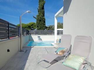 Pool with solar-shower and massage-waterfall