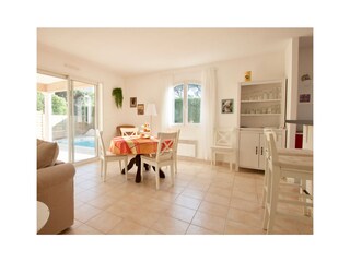 Dining area in living with doors to terrace