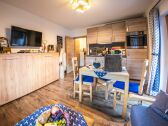 Living room with dining table and kitchenette.