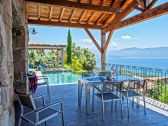 View of the sea and the pool from the terrace of one of